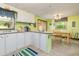 Bright eat-in kitchen with white cabinets, a dining area, and a bar top, creating a warm, inviting space at 394 Flanagan Rd, Henderson, NC 27537