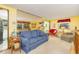 Cozy living room featuring a comfortable blue sofa, unique mirrored wall, and a bright, cheerful ambiance at 394 Flanagan Rd, Henderson, NC 27537