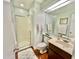 Bright bathroom with a glass door shower, wood floors, vanity with storage, and brushed nickel finishes at 406 Fairoaks Cir, Chapel Hill, NC 27516