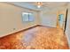 Spacious bedroom features hardwood floors, a ceiling fan, and a large window for ample natural light at 406 Fairoaks Cir, Chapel Hill, NC 27516