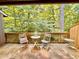 Relaxing deck space surrounded by lush greenery, perfect for outdoor seating and enjoying nature at 406 Fairoaks Cir, Chapel Hill, NC 27516