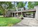 Inviting condo complex featuring mature landscaping, covered parking, and private entrance at 406 Fairoaks Cir, Chapel Hill, NC 27516