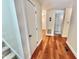 Bright hallway with hardwood floors, connecting various rooms in this well-maintained condo at 406 Fairoaks Cir, Chapel Hill, NC 27516