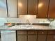 Kitchen area includes undermount stainless steel sink, wooden cabinets, and neutral countertops at 406 Fairoaks Cir, Chapel Hill, NC 27516