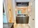 View of the kitchen, featuring a wine rack and granite countertops with a pass-through to the living room at 406 Fairoaks Cir, Chapel Hill, NC 27516