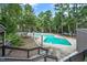 Community pool surrounded by mature trees and landscaping, offering a relaxing atmosphere at 406 Fairoaks Cir, Chapel Hill, NC 27516