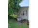 The backyard of the house featuring green grass, air conditioner, and a cement staircase at 411 W Raleigh St, Siler City, NC 27344