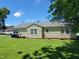 Spacious backyard with lush green grass, showcasing the home's exterior and ample outdoor space at 411 W Raleigh St, Siler City, NC 27344
