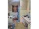 Bathroom featuring toilet, sink, vanity, bathtub and shower with blue shower curtain at 411 W Raleigh St, Siler City, NC 27344