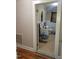 Bathroom featuring toilet, sink, wall mirror, tile flooring and a small window at 411 W Raleigh St, Siler City, NC 27344