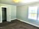 Cozy bedroom featuring neutral carpet, closet and a window at 411 W Raleigh St, Siler City, NC 27344