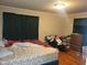 Bedroom with a floral bedspread, a dresser, and hardwood flooring at 411 W Raleigh St, Siler City, NC 27344