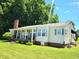 Charming single story home with well-manicured lawn, mature trees, and brick foundation at 411 W Raleigh St, Siler City, NC 27344