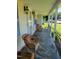 Front porch featuring rocking chairs, decorative sconces, and stone flooring at 411 W Raleigh St, Siler City, NC 27344