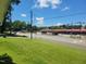 A view of a street featuring a Maxway store, captured from a well-manicured front yard, framed by a blue sky at 411 W Raleigh St, Siler City, NC 27344