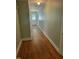 Inviting hallway with beautiful hardwood floors and neutral paint leading to a white paneled front door at 411 W Raleigh St, Siler City, NC 27344