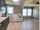 Bright kitchen with updated appliances, ample cabinet space, and a breakfast nook area with natural light at 411 W Raleigh St, Siler City, NC 27344