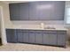 Kitchen features new cabinets, laminate countertops and tile flooring at 411 W Raleigh St, Siler City, NC 27344