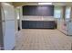 Open kitchen with blue cabinets, modern appliances, and a bright, functional layout, including laundry at 411 W Raleigh St, Siler City, NC 27344