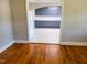 View of a kitchen with blue cabinets and an adjacent space with hardwood floors at 411 W Raleigh St, Siler City, NC 27344