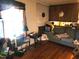 Living room featuring hardwood floors, a brick fireplace, and a comfortable sofa at 411 W Raleigh St, Siler City, NC 27344