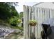 View of backyard with a grill and fence adorned with hanging flowers, with trees in the background at 4224 Vienna Crest Drive Dr, Raleigh, NC 27613