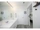 Well-lit bathroom featuring double sinks and a sliding barn door at 4224 Vienna Crest Drive Dr, Raleigh, NC 27613