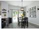Bright dining room features a sliding glass door to the exterior, with gray floors and black table set at 4224 Vienna Crest Drive Dr, Raleigh, NC 27613