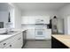 Bright kitchen featuring white cabinets, stainless steel appliances and mosaic backsplash at 4224 Vienna Crest Drive Dr, Raleigh, NC 27613