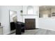 Bright living room features a white fireplace with decor, with gray floors and a stylish black chair and mirror at 4224 Vienna Crest Drive Dr, Raleigh, NC 27613