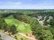An aerial view of a verdant golf course with mature trees scattered throughout the landscape at 4229 Cats Paw Ct, Wake Forest, NC 27587