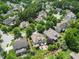 Aerial of a neighborhood showing manicured lawns, mature trees and outdoor patio with sitting around a fire pit at 4229 Cats Paw Ct, Wake Forest, NC 27587
