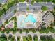 Aerial view of community pool, clubhouse, playground, parking, and surrounding green spaces at 4229 Cats Paw Ct, Wake Forest, NC 27587