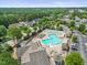 Aerial view of a community pool and amenity center with seating areas and lush landscaping at 4229 Cats Paw Ct, Wake Forest, NC 27587