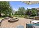 Backyard features a stone fire pit, a grill and pristine landscaping in a relaxing outdoor oasis at 4229 Cats Paw Ct, Wake Forest, NC 27587