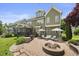 Expansive backyard boasting a custom stone fire pit, outdoor cooking area and lush green lawn at 4229 Cats Paw Ct, Wake Forest, NC 27587
