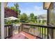 Backyard deck overlooking professionally landscaped yard with stone-lined flower beds and fire pit area at 4229 Cats Paw Ct, Wake Forest, NC 27587