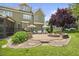 Beautiful backyard with patio, stone fire pit, lush lawn, mature trees, and manicured landscaping at 4229 Cats Paw Ct, Wake Forest, NC 27587