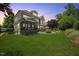 Sprawling backyard featuring a screened porch, patio with fire pit, and lush, well-maintained lawn at 4229 Cats Paw Ct, Wake Forest, NC 27587