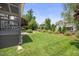Manicured backyard with verdant lawn, mature trees and extensive landscaping that provide privacy at 4229 Cats Paw Ct, Wake Forest, NC 27587