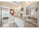 Bathroom featuring double sinks, granite countertops, and natural light at 4229 Cats Paw Ct, Wake Forest, NC 27587