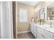 Bathroom featuring a tiled shower, and a double sink white vanity with neutral walls and floor at 4229 Cats Paw Ct, Wake Forest, NC 27587