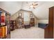 Cozy bedroom featuring a ceiling fan, tan carpet, and shelving for books and collectables at 4229 Cats Paw Ct, Wake Forest, NC 27587