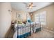 Bedroom features two twin beds with brass frames, a ceiling fan and neutral walls and carpet at 4229 Cats Paw Ct, Wake Forest, NC 27587