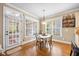Bright breakfast nook with hardwood floors, white trim, and views to the screened in porch at 4229 Cats Paw Ct, Wake Forest, NC 27587