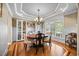 Elegant dining room featuring hardwood floors, tray ceilings, and large window at 4229 Cats Paw Ct, Wake Forest, NC 27587