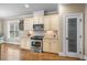 Well appointed kitchen with stainless appliances, decorative pantry door, and hardwood floors at 4229 Cats Paw Ct, Wake Forest, NC 27587