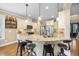 Open-concept kitchen featuring granite countertops, stainless steel appliances, and hardwood floors at 4229 Cats Paw Ct, Wake Forest, NC 27587