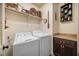 Bright laundry room featuring a washer, dryer, neutral cabinets, and countertop space at 4229 Cats Paw Ct, Wake Forest, NC 27587
