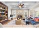 Inviting living room with stone fireplace, tray ceiling, ceiling fan, and hardwood floors at 4229 Cats Paw Ct, Wake Forest, NC 27587